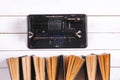 Vintage mechanical calculator and books, on a white rustic wooden background. Royalty Free Stock Photo