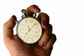 Vintage mechanical wind up stop watch held in left hand with fingers on reset positions, white background Royalty Free Stock Photo