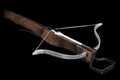 Vintage medieval crossbow with bolt on black