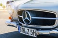 A vintage MERCEDES-BENZ 190 SL. Front view of the bumper, hood, grille and headlights.