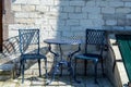 Vintage metal bistro table and chairs set in outdoor cafe Royalty Free Stock Photo