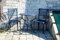 Vintage metal bistro table and chairs set in outdoor cafe Royalty Free Stock Photo