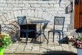 Vintage metal bistro table and chairs set in outdoor cafe Royalty Free Stock Photo