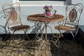 Vintage metal bistro table and chairs set in outdoor cafe Royalty Free Stock Photo