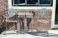 Vintage metal bistro table and chairs set in outdoor cafe Royalty Free Stock Photo