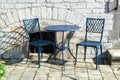 Vintage metal bistro table and chairs set in outdoor cafe Royalty Free Stock Photo