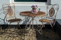 Vintage metal bistro table and chairs set in outdoor cafe Royalty Free Stock Photo