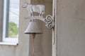 Vintage Metal Cow Bell Hanging on a Wall with Rustic Charm Royalty Free Stock Photo