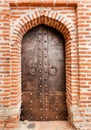 Vintage metal door of historical building with brick walls Royalty Free Stock Photo