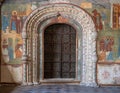 Vintage metal door old ancient antique doors inside the temple, the walls are painted with frescoes on religious biblical themes