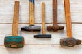 Vintage metal hammers on a white wooden table