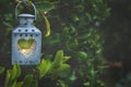 Vintage Metal Heart Shape Candle Holder Lit Burning Flame Hanging on Tree Branch in Garden. Valentine Mother`s Day Royalty Free Stock Photo