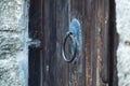 Vintage metal iron door handle on an old door made of natural wood. Horizontal orientation, selective focus. Doorknocker Royalty Free Stock Photo