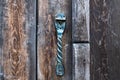 Vintage metal iron door handle on an old door made of natural wood. Horizontal orientation, selective focus. Doorknocker Royalty Free Stock Photo