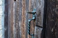 Vintage metal iron door handle on an old door made of natural wood. Horizontal orientation, selective focus. Doorknocker Royalty Free Stock Photo