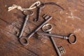 Vintage metal keys arranged on a distressed wooden tabletop