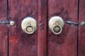 Vintage metal knobs with a ring on an old wooden door close-up Royalty Free Stock Photo