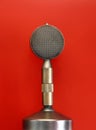 Vintage metal microphone over red