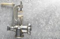 Vintage metal mincer on a gray concrete background. Top View.