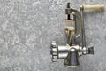 Vintage metal mincer on a gray concrete background. Top View.