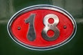 Vintage metal plate with number eighteen, detail of an old metal plate