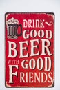 Retro-looking metal plaque with the inscription Drink good beer with good friends