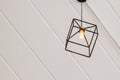 Vintage metal square lamp hanging on ceiling.