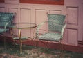 A vintage table and chairs are made wicker weave