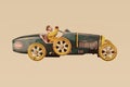 Vintage metal toy racing car with driver on a sepia background Royalty Free Stock Photo