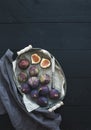 Vintage metal tray of fresh figs on dark background, top view, selective focus. Royalty Free Stock Photo