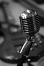 Vintage Microphone with Electric Guitar in Background, Black and White Royalty Free Stock Photo