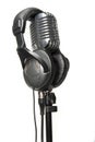 Vintage Microphone with modern headphones Royalty Free Stock Photo
