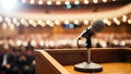 Vintage microphone on a podium in an empty auditorium with blurred audience lights Royalty Free Stock Photo