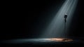 Vintage Microphone on Stage with Dramatic Lighting in Dark Room Royalty Free Stock Photo