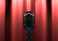 Vintage microphone on stage with red curtains. Moody stage light Royalty Free Stock Photo