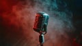 Vintage microphone stands bathed in red stage lights creating a dramatic atmosphere for performance Royalty Free Stock Photo