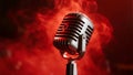 Vintage microphone stands bathed in red stage lights creating a dramatic atmosphere for performance Royalty Free Stock Photo