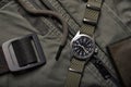 Vintage military watch and leather wallet on army green background, Classic timepiece mechanical wristwatch, Men fashion