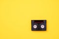 Vintage mini DV cassette tape used for recording video back in a day. Plastic, magnetic, analog film tape on yellow background