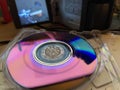 Vintage mini DVD disk in a case and camera blurred screen Royalty Free Stock Photo