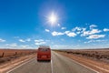 Vintage minivan driving on rural road. Royalty Free Stock Photo