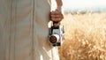 Vintage 8mm cinema camera in the hand of a girl walking in the countryside Royalty Free Stock Photo