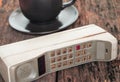 Vintage mobile phone with coffee cup Royalty Free Stock Photo