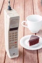 Vintage mobile phone with cup