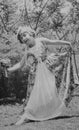 Vintage monochrome photograph of cute Caucasian girl in fancy dress outfit, dating to the 1930s, Edwardian era.