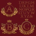 Vintage monogram kit. Golden patterned letters and floral coat of arms frames for creating initial logo in antique style