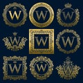 Vintage monograms set of W letter. Golden heraldic logos in wreaths, round and square frames Royalty Free Stock Photo