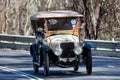 Vintage Mor automobile driving on country road