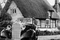 Vintage Motor Car outside a Thatched Cottage Royalty Free Stock Photo