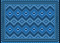 Vintage mottled carpet with ethnic diamond patterns in blue and gray-blue shades on a black background